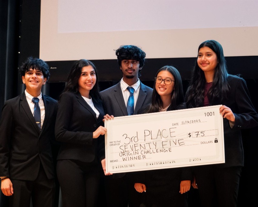 A team holding a third-place check.