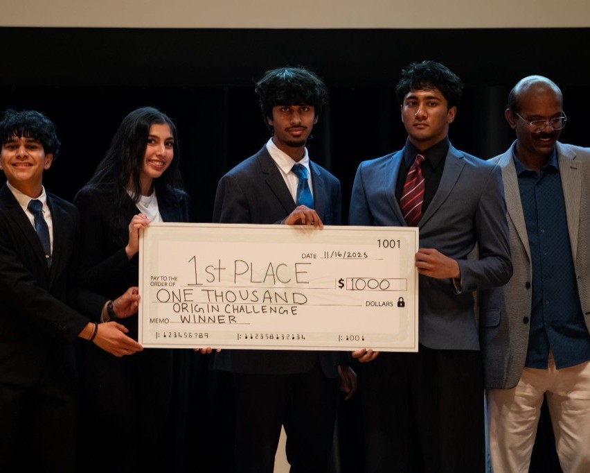A team holding a first-place check.